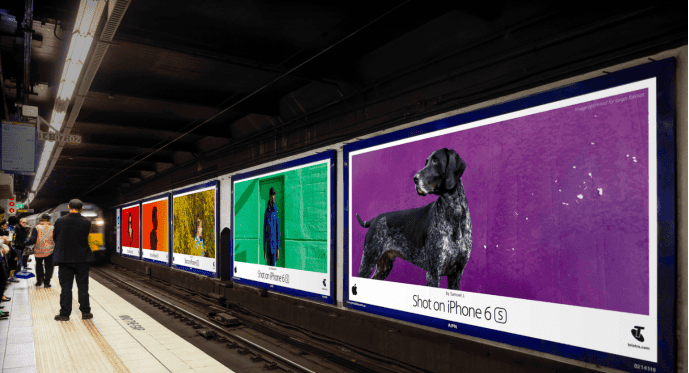 A subway platform featuring vibrant advertisements showcasing images shot on an iPhone 6S, exemplifies Apple's strategic use of ROI tracking in marketing. Each visually appealing ad demonstrates the phone's camera quality, effectively attracting commuters' attention and driving product interest, highlighting the successful return on investment (ROI) from Apple's creative advertising campaigns.